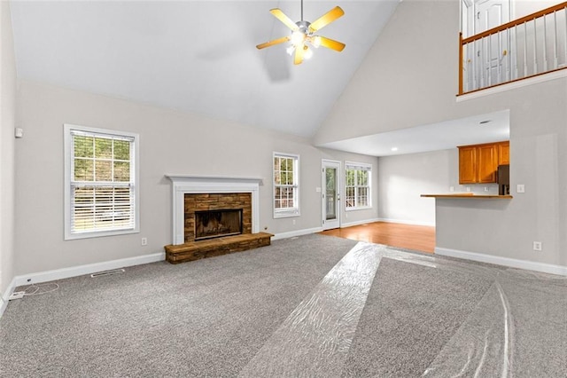 2443 High Meadows Ct, Conyers, GA 30094 - unfurnished living room featuring carpet flooring, a ceiling fan, high vaulted ceiling, and baseboards