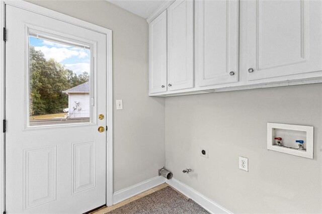 2443 High Meadows Ct, Conyers, GA 30094 - laundry area with hookup for a gas dryer, hookup for a washing machine, baseboards, electric dryer hookup, and cabinet space
