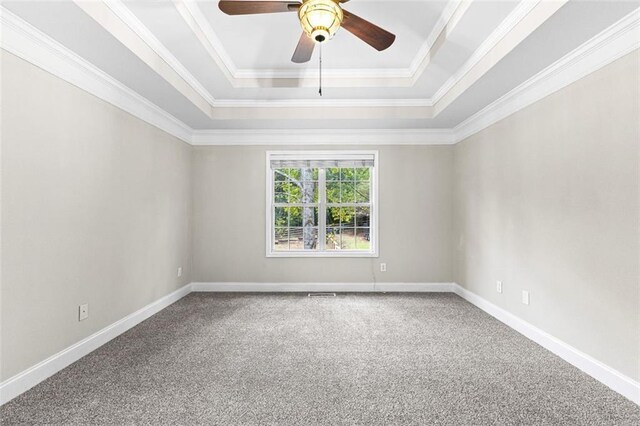 2443 High Meadows Ct, Conyers, GA 30094 - carpeted spare room with a ceiling fan, ornamental molding, a tray ceiling, and baseboards