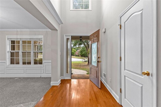 2443 High Meadows Ct, Conyers, GA 30094 - foyer entrance featuring visible vents, a healthy amount of sunlight, crown molding, and light colored carpet