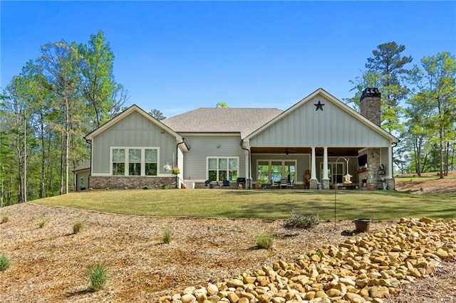 131 Quiet Cove Way, Monticello, GA 31064 - rear view of property with board and batten siding, a ceiling fan, a chimney, a yard, and a patio area