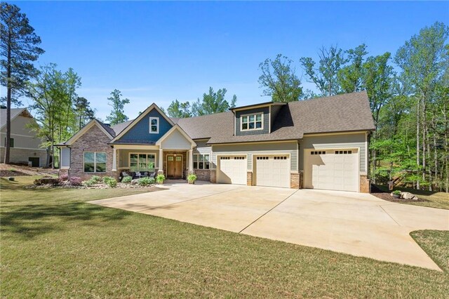 131 Quiet Cove Way, Monticello, GA 31064 - craftsman house featuring brick siding, concrete driveway, a front lawn, a garage, and a shingled roof