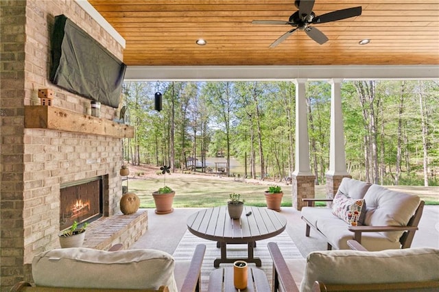 131 Quiet Cove Way, Monticello, GA 31064 - view of patio featuring an outdoor living space with a fireplace, a ceiling fan, and view of scattered trees