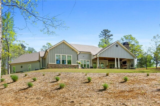 131 Quiet Cove Way, Monticello, GA 31064 - view of front of house with board and batten siding, a chimney, and a ceiling fan