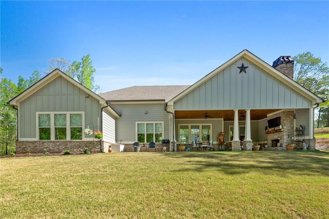 131 Quiet Cove Way, Monticello, GA 31064 - back of property featuring ceiling fan, board and batten siding, a chimney, and a lawn