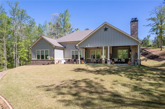 131 Quiet Cove Way, Monticello, GA 31064 - rear view of house with a ceiling fan, board and batten siding, a yard, a chimney, and outdoor lounge area