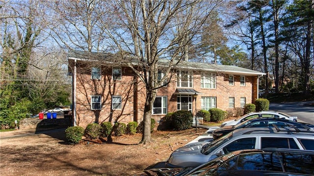 colonial inspired home with brick siding