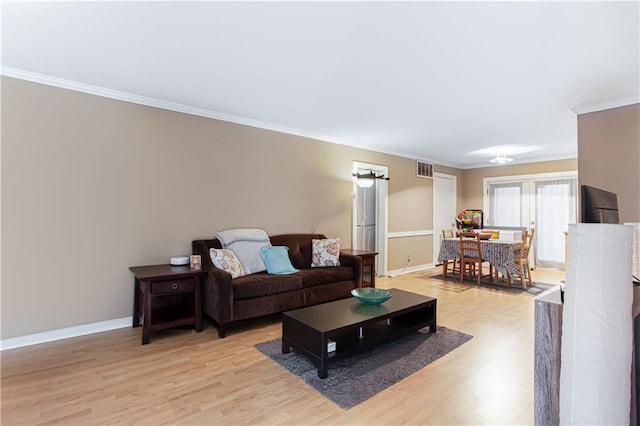 living room with light hardwood / wood-style floors and ornamental molding