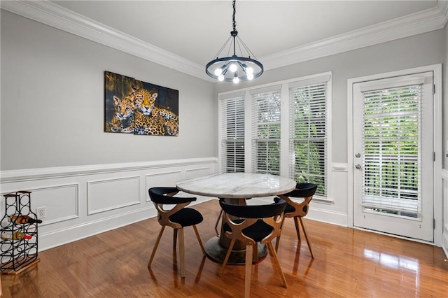 2873 Overlook Way NE, Atlanta, GA 30324 - dining area with ornamental molding, wood finished floors, a chandelier, a decorative wall, and wainscoting