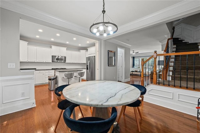 2873 Overlook Way NE, Atlanta, GA 30324 - dining area featuring crown molding, stairs, wood finished floors, a chandelier, and recessed lighting