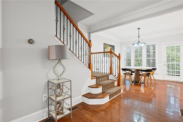 2873 Overlook Way NE, Atlanta, GA 30324 - stairs featuring wood finished floors, a chandelier, and crown molding