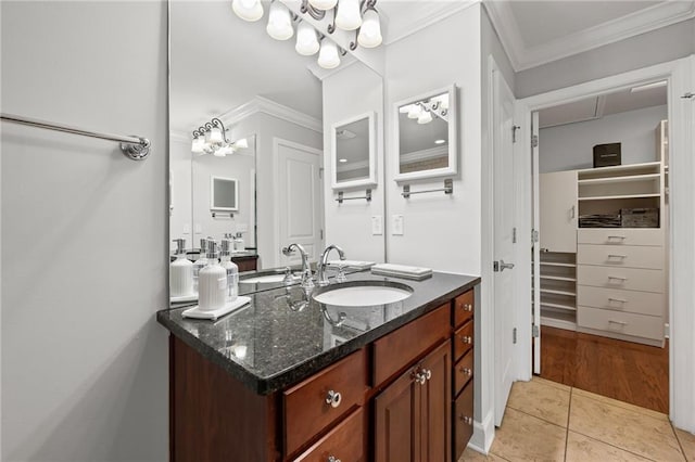 2873 Overlook Way NE, Atlanta, GA 30324 - bathroom featuring vanity, a spacious closet, crown molding, tile patterned floors, and a chandelier
