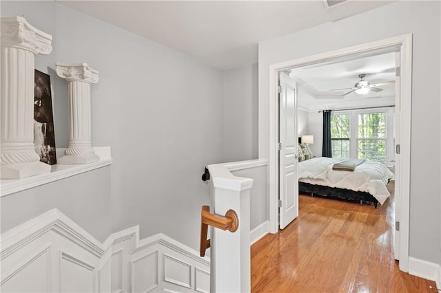 2873 Overlook Way NE, Atlanta, GA 30324 - hallway with light wood-style flooring, an upstairs landing, and ornate columns