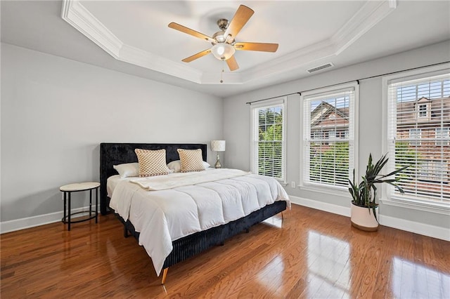 2873 Overlook Way NE, Atlanta, GA 30324 - bedroom with a raised ceiling, crown molding, wood finished floors, and a ceiling fan