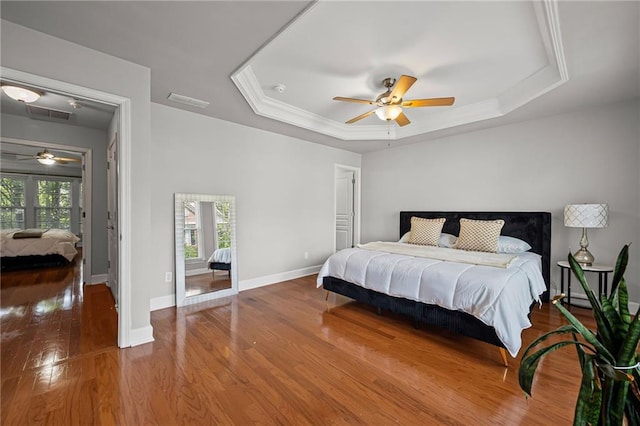 2873 Overlook Way NE, Atlanta, GA 30324 - bedroom featuring a tray ceiling, wood finished floors, ceiling fan, and crown molding