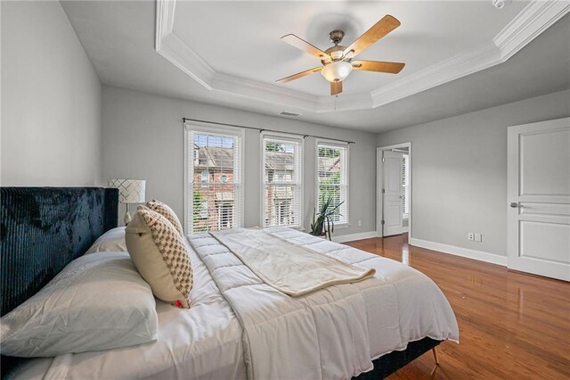2873 Overlook Way NE, Atlanta, GA 30324 - bedroom with a raised ceiling, wood finished floors, ornamental molding, and ceiling fan