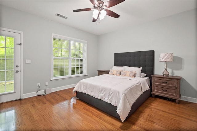 2873 Overlook Way NE, Atlanta, GA 30324 - bedroom featuring wood finished floors, multiple windows, and a ceiling fan
