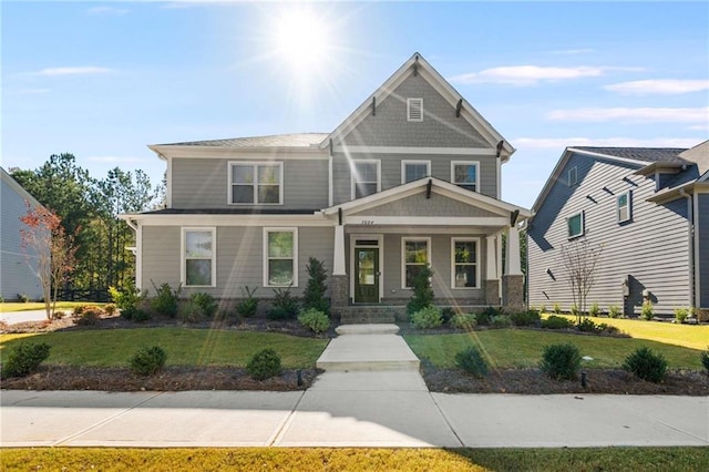 craftsman house featuring a front lawn and covered porch