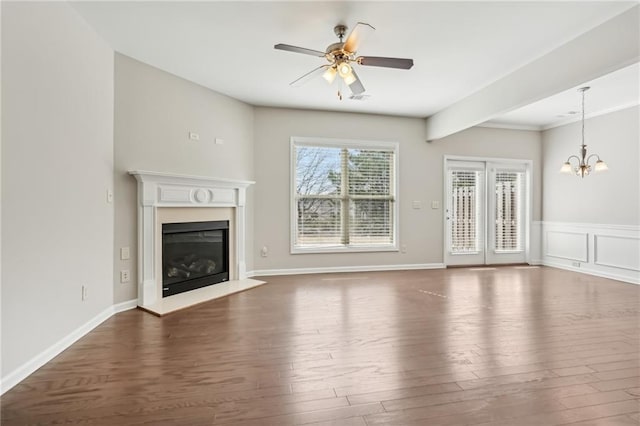 2785 Maple Park Pl, Cumming, GA 30041 - unfurnished living room featuring ceiling fan with notable chandelier, a glass covered fireplace, wood finished floors, and visible vents