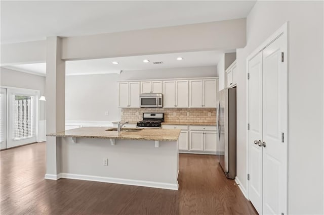 2785 Maple Park Pl, Cumming, GA 30041 - kitchen with light stone countertops, dark wood-style floors, stainless steel appliances, and a sink