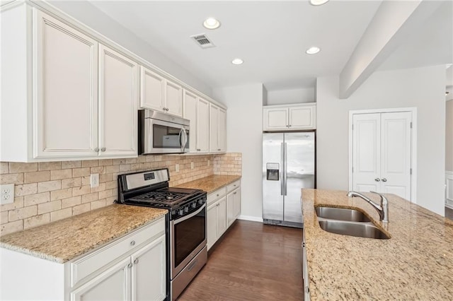 2785 Maple Park Pl, Cumming, GA 30041 - kitchen with stainless steel appliances, tasteful backsplash, visible vents, a sink, and light stone countertops