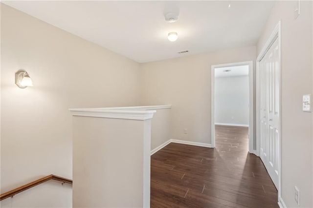 2785 Maple Park Pl, Cumming, GA 30041 - hall with baseboards, visible vents, dark wood finished floors, and an upstairs landing