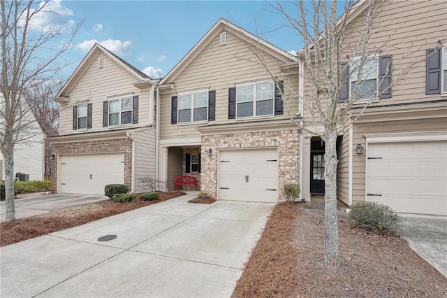 2785 Maple Park Pl, Cumming, GA 30041 - townhome / multi-family property with brick siding, driveway, and an attached garage