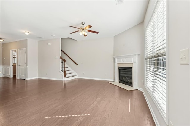 2785 Maple Park Pl, Cumming, GA 30041 - unfurnished living room featuring stairway, a ceiling fan, a glass covered fireplace, wood finished floors, and baseboards