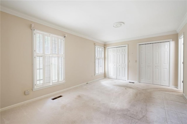 170 Mayfield Cir, Alpharetta, GA 30009 - unfurnished bedroom with two closets, ornamental molding, baseboards, and multiple windows