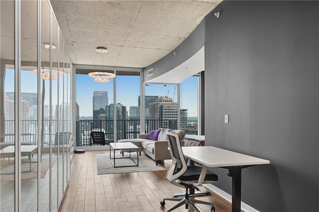 office space featuring floor to ceiling windows and a notable chandelier