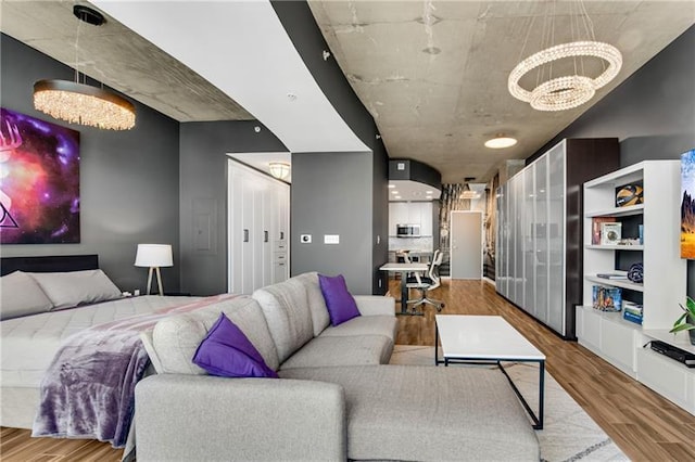 living room with wood-type flooring and a notable chandelier