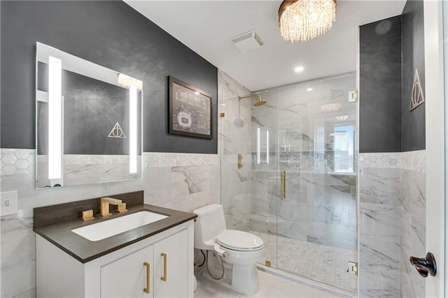 bathroom with walk in shower, vanity, tile walls, a notable chandelier, and toilet