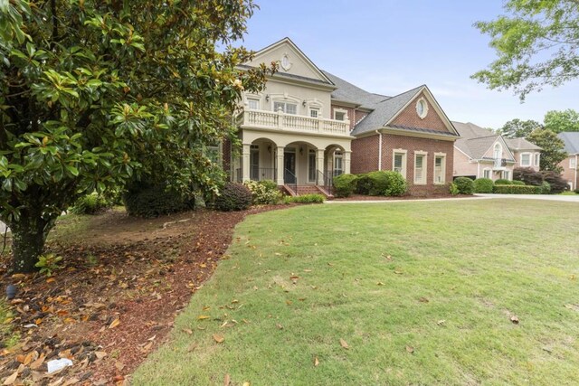 1565 Briergate Dr, Duluth, GA 30097 - view of front of home featuring a balcony, a porch, brick siding, and a front yard