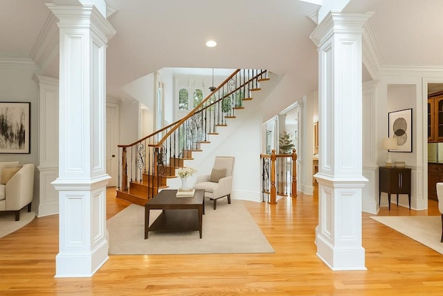 1565 Briergate Dr, Duluth, GA 30097 - entryway featuring decorative columns, light wood-style flooring, stairs, recessed lighting, and ornamental molding