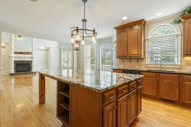 1565 Briergate Dr, Duluth, GA 30097 - kitchen with light wood finished floors, a center island, dark stone counters, a chandelier, and backsplash