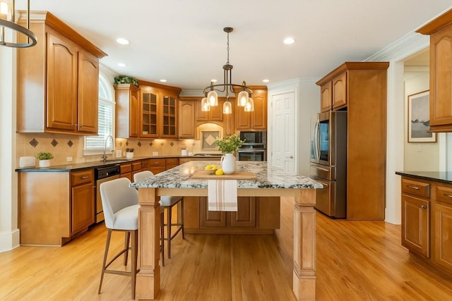 1565 Briergate Dr, Duluth, GA 30097 - kitchen with stainless steel appliances, a center island, a breakfast bar area, light wood-style floors, and recessed lighting