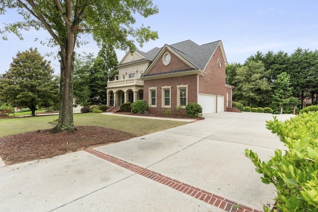 1565 Briergate Dr, Duluth, GA 30097 - view of front of property featuring brick siding, driveway, a garage, a balcony, and a front lawn