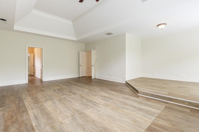 1565 Briergate Dr, Duluth, GA 30097 - unfurnished room with a tray ceiling, wood finished floors, and ceiling fan