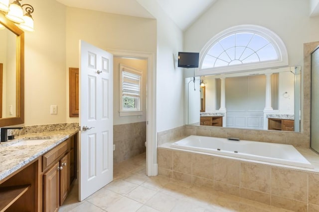 1565 Briergate Dr, Duluth, GA 30097 - bathroom featuring healthy amount of natural light, vanity, vaulted ceiling, a bath, and tile patterned flooring