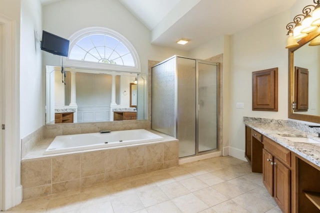 1565 Briergate Dr, Duluth, GA 30097 - full bathroom featuring vanity, a shower stall, a garden tub, tile patterned floors, and vaulted ceiling