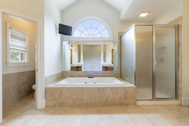 1565 Briergate Dr, Duluth, GA 30097 - bathroom featuring a shower stall, a garden tub, lofted ceiling, and tile patterned floors