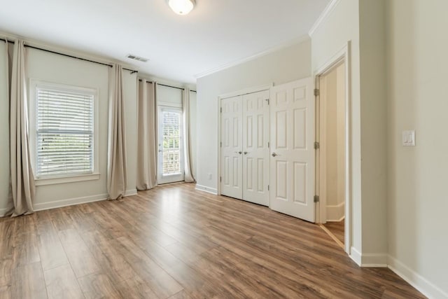 1565 Briergate Dr, Duluth, GA 30097 - unfurnished bedroom featuring ornamental molding and wood finished floors