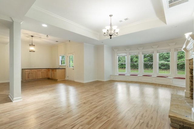 1565 Briergate Dr, Duluth, GA 30097 - unfurnished living room featuring light wood finished floors, a chandelier, ornamental molding, a raised ceiling, and a fireplace