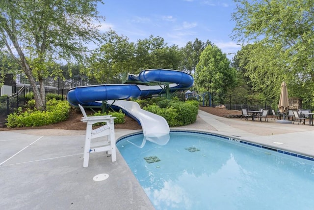 1565 Briergate Dr, Duluth, GA 30097 - community pool with a water slide, a patio area, and view of wooded area
