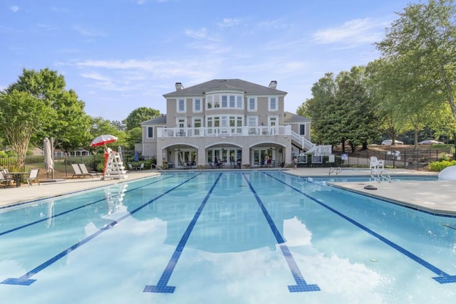 1565 Briergate Dr, Duluth, GA 30097 - back of property with a community pool, a chimney, and a patio