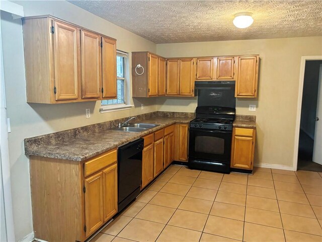 kitchen featuring exhaust hood, black appliances, sink, and light tile patterned flooring