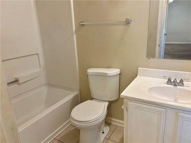 full bathroom featuring toilet, vanity, tile patterned floors, and  shower combination