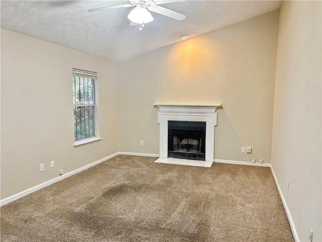 unfurnished living room with carpet, a textured ceiling, and ceiling fan