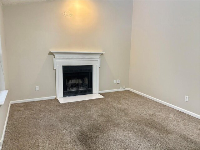 unfurnished living room featuring carpet flooring