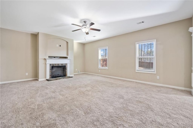 unfurnished living room featuring light colored carpet and ceiling fan